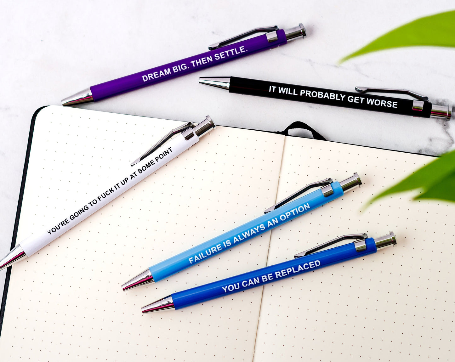 Set of demotivational pens with sarcastic phrases, perfect for dark humor lovers.