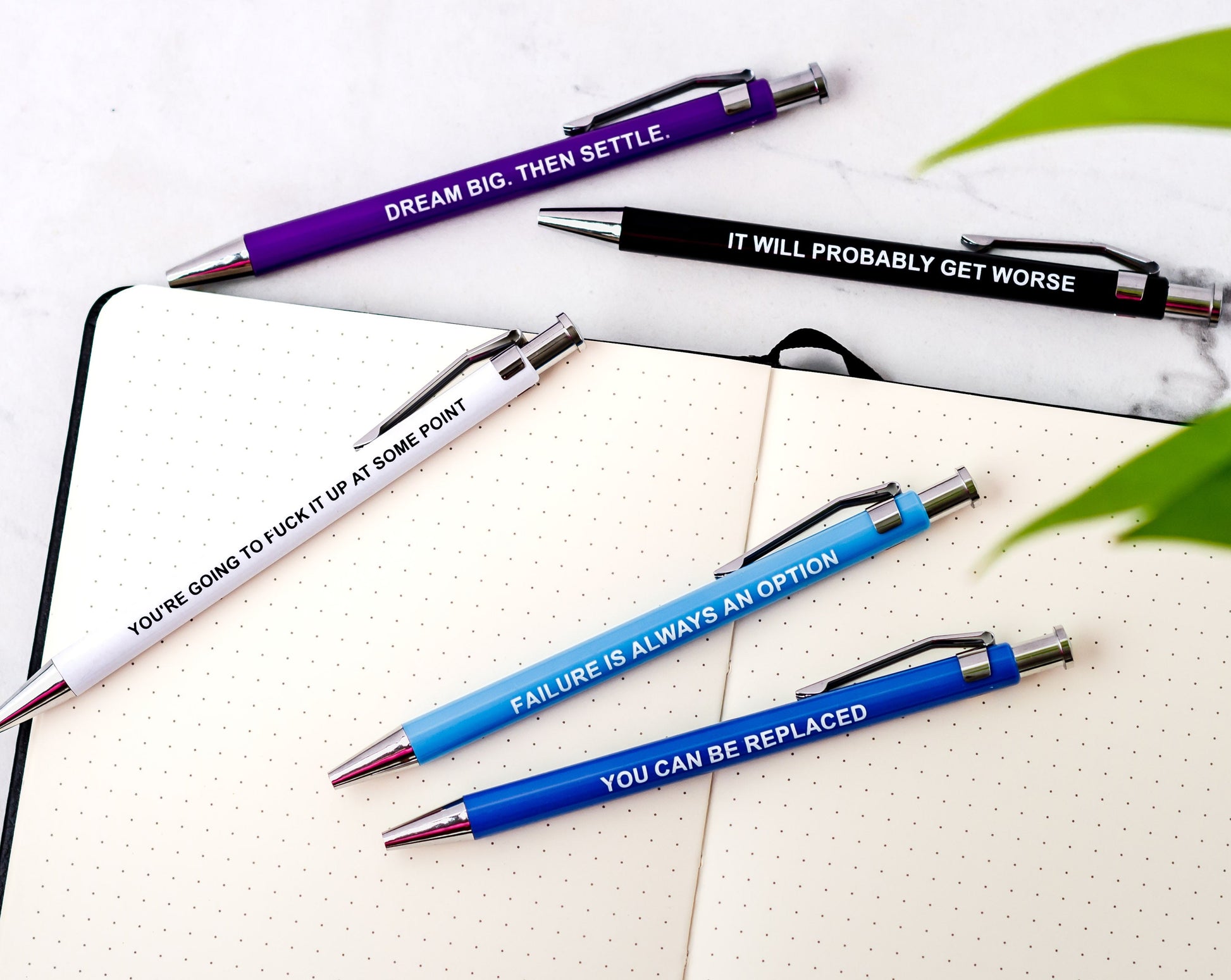 Set of demotivational pens with sarcastic phrases, perfect for dark humor lovers.