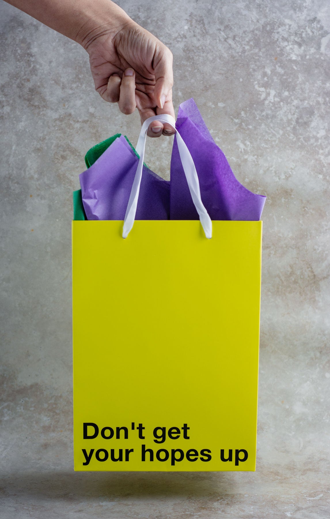 "Don't Get Your Hopes Up" yellow gift bag – Funny, snarky kraft gift bag with white ribbon.