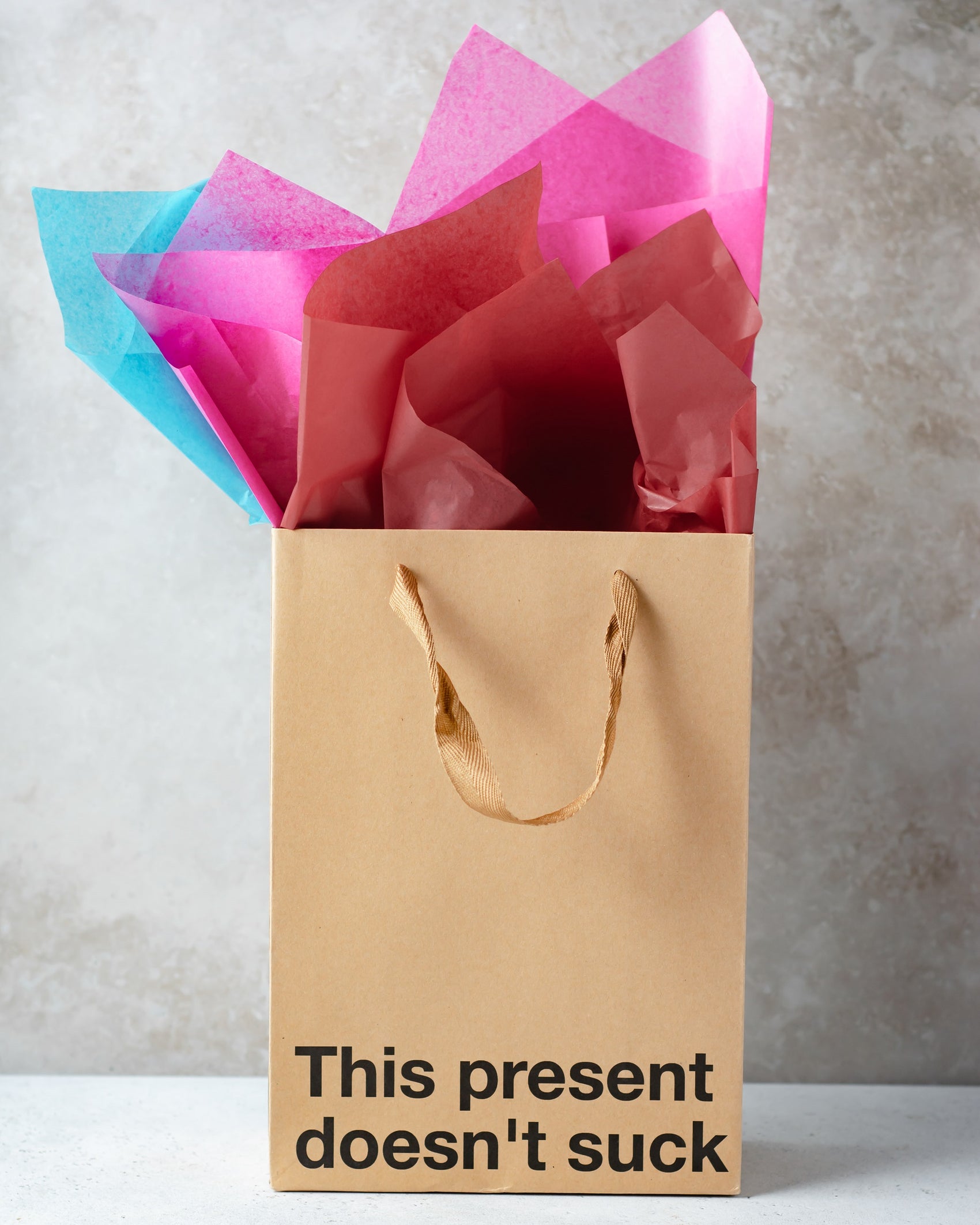 Kraft gift bag with brown ribbon handle, great for adult gifts.