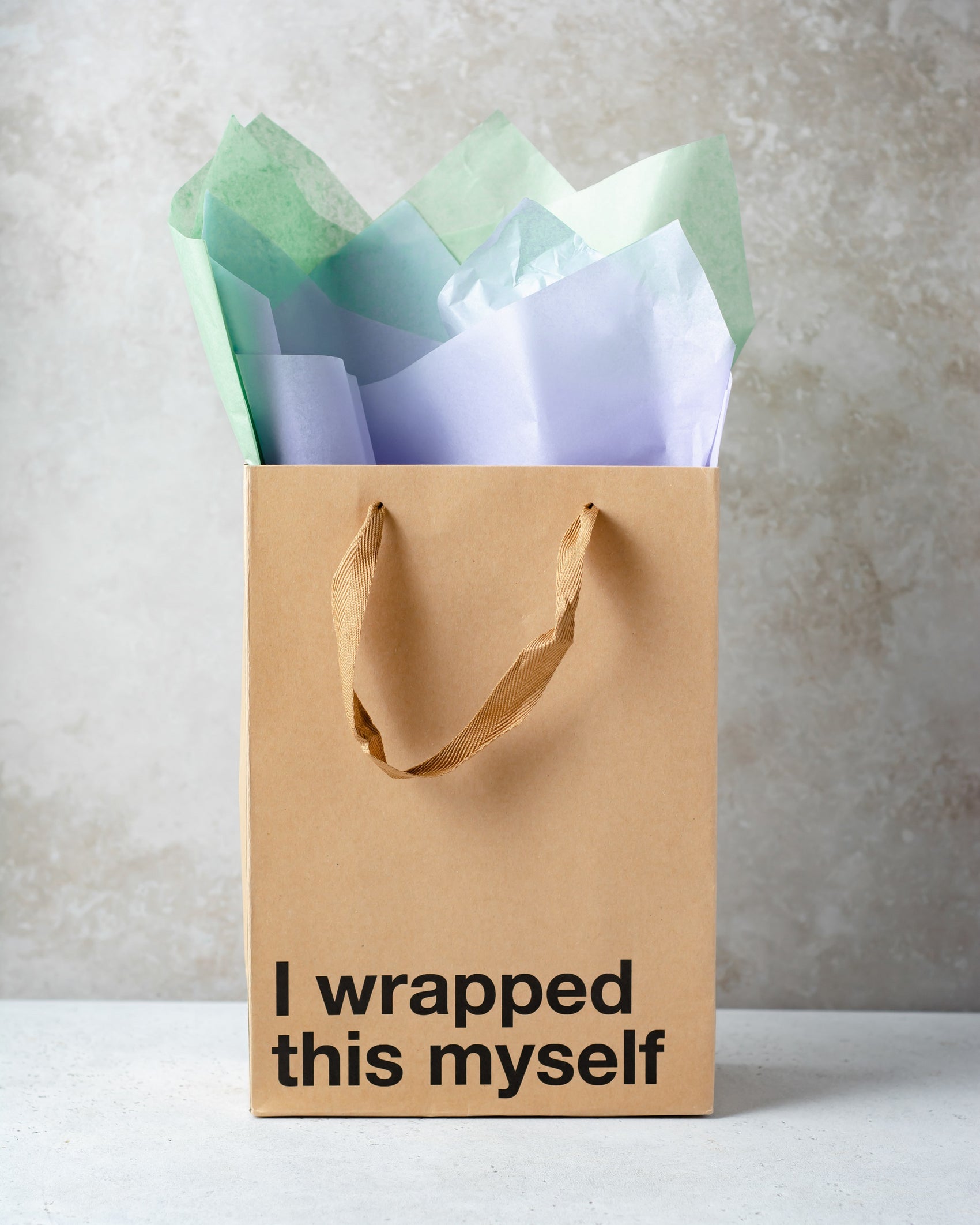 Kraft gift bag with brown ribbon handle, perfect for adult gifts.