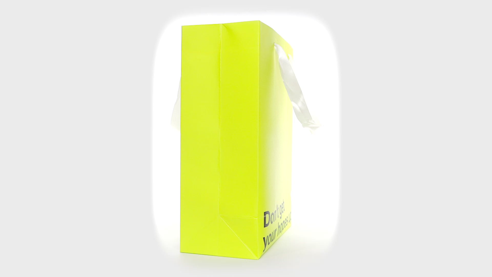 "Don't Get Your Hopes Up" yellow gift bag – Funny, snarky kraft gift bag with white ribbon.